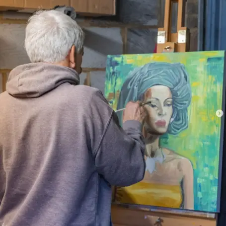 Simon Hickman in his studio with easel and painting